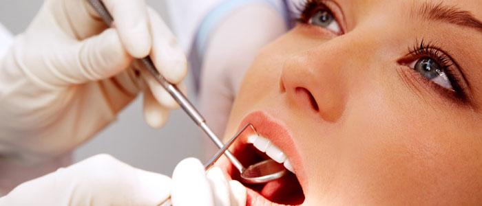 Photo of a woman during an oral examination at a dentist's office.